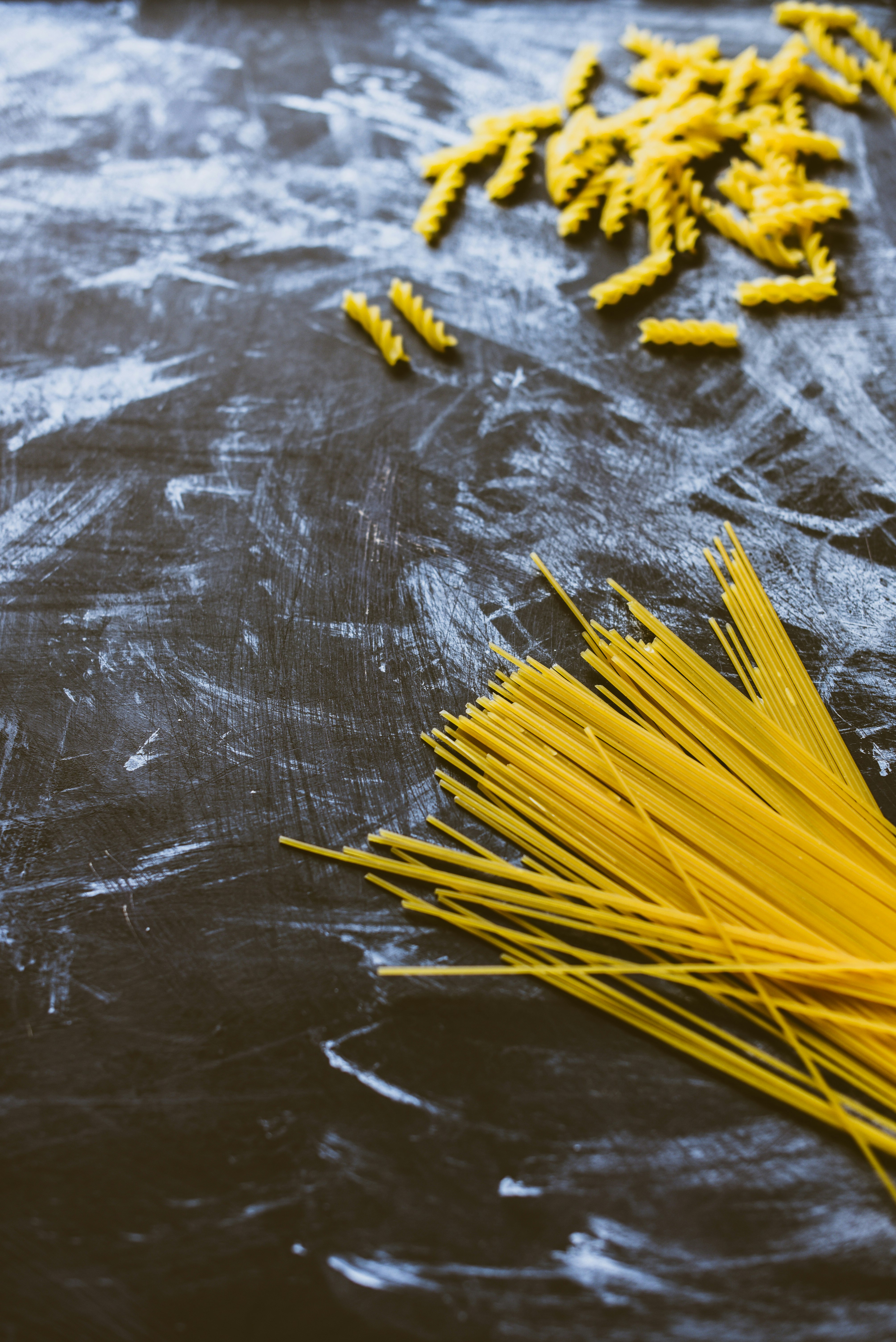 yellow pasta on black wooden table